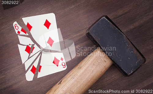 Image of Hammer with a broken card, six of diamonds