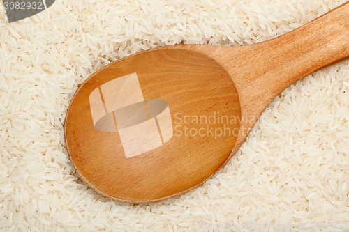 Image of Wooden spoon on Thai fragrant jasmine rice