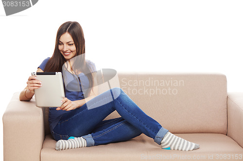 Image of Woman with tablet on sofa