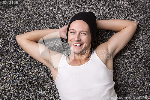 Image of Attractive man in a white shirt smiles at the camera