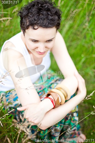 Image of cute girl resting on fresh spring grass 