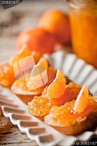 Image of pieces of baguette with orange marmalade 