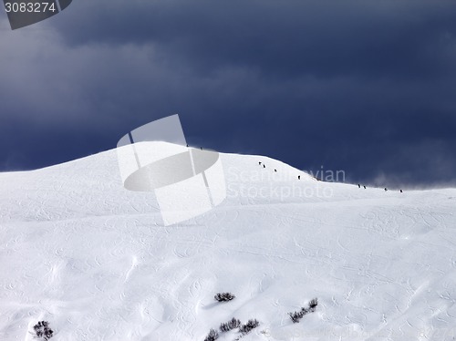 Image of Off-piste slope and storm gray sky in bad weather day