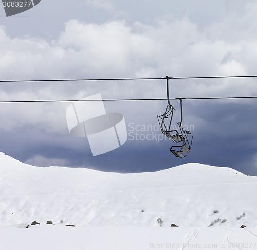 Image of Chair lifts and off piste slope at gray day