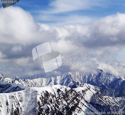 Image of Winter snowy mountains and cloudy sky