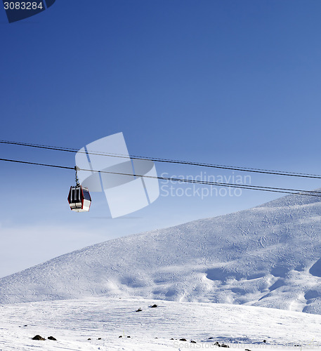 Image of Gondola lift and ski slope at nice sun day