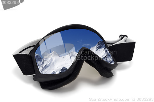 Image of Ski goggles with reflection of snowy mountains in nice day