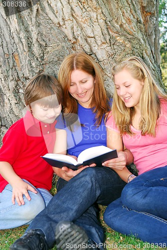 Image of Family reading a book