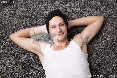 Image of Attractive man in a white shirt smiles at the camera