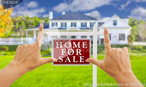 Image of Hands Framing For Sale Real Estate Sign and New House