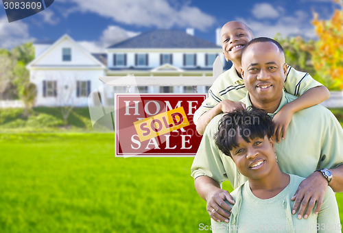 Image of African American Family In Front of Sold Sign and House