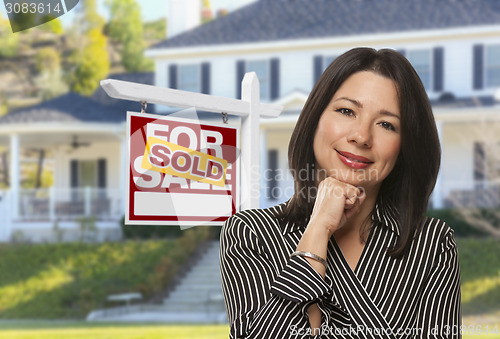 Image of Hispanic Woman in Front of Sold Sign and House