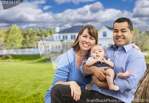 Image of Happy Mixed Race Young Family in Front of House