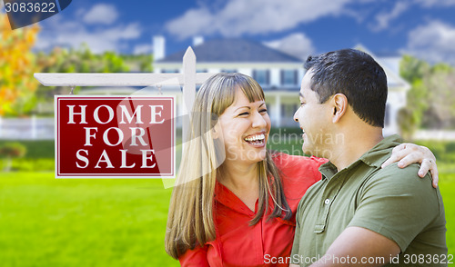 Image of Couple in Front of For Sale Sign and House