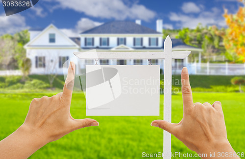 Image of Hands Framing Blank Real Estate Sign and New House