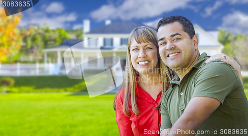 Image of Happy Mixed Race Couple in Front of House