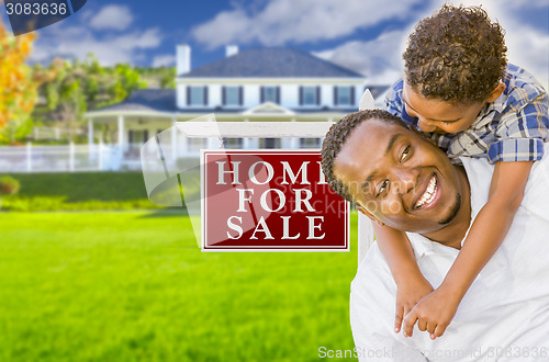 Image of Father and Son In Front of Sale Sign and House