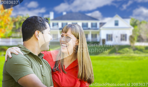 Image of Happy Mixed Race Couple in Front of House