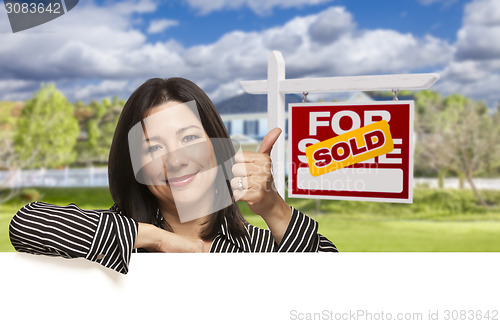 Image of Hispanic Woman in Front of Sold For Sale Sign, House