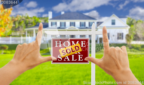 Image of Hands Framing Sold For Sale Real Estate Sign and House