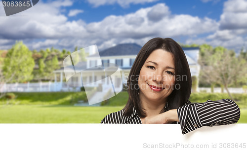 Image of Hispanic Woman Leaning on White in Front of House