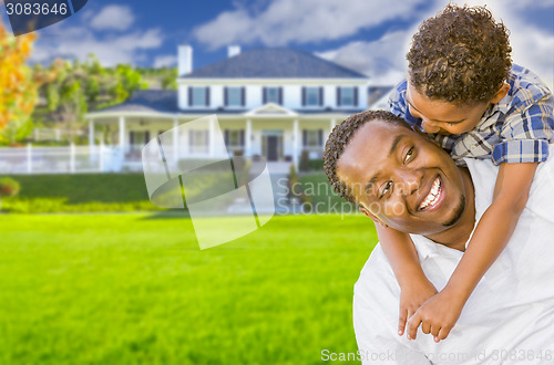 Image of Mixed Race Father and Son In Front of House