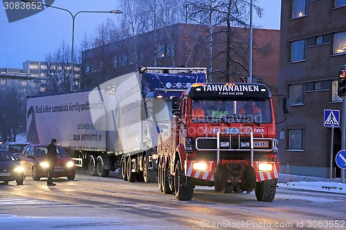 Image of Full Trailer Truck being Towed in City