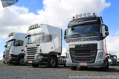 Image of Row of White Volvo and Scania Trucks