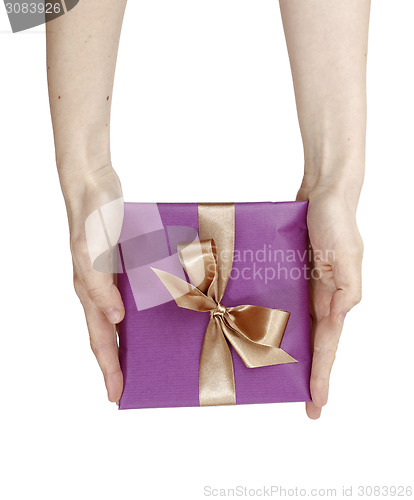 Image of Young woman holding a present