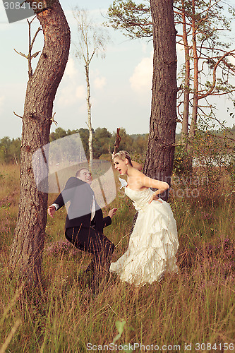 Image of Bride threatens your wedded husband with a stick