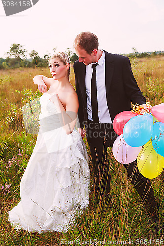 Image of Funny wedding couple with balloons