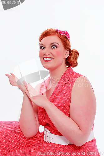 Image of Young red-haired woman with voluptuous curves