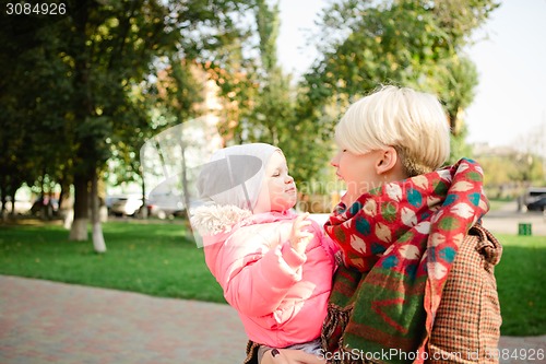 Image of Beautiful Mother And Baby outdoors.