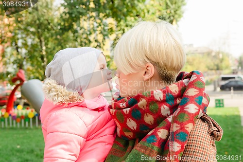 Image of Beautiful Mother And Baby outdoors.