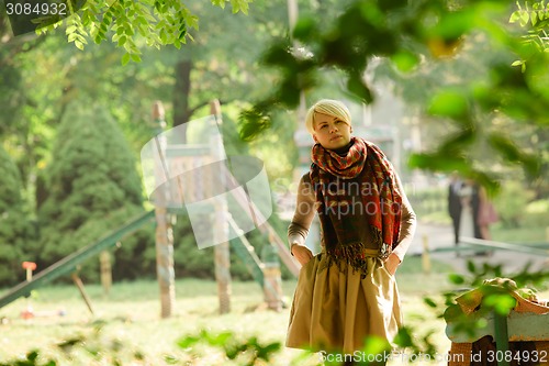 Image of Portrait of young attractive woman at green park.