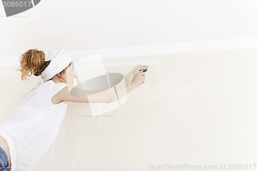 Image of A woman painting wall