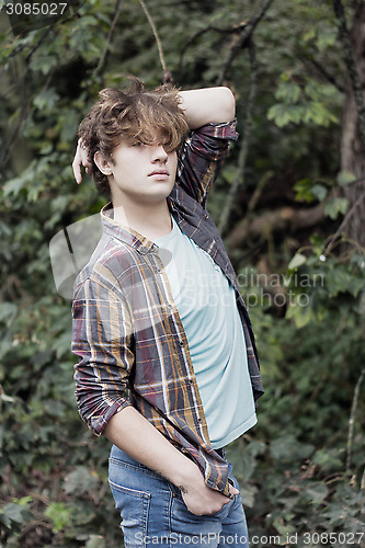 Image of good looking man posing in outdoor setting