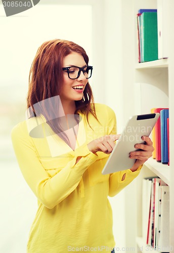 Image of smiling female student with tablet pc in library