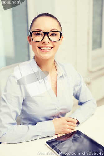 Image of smiling businesswoman in eyeglasses with tablet pc