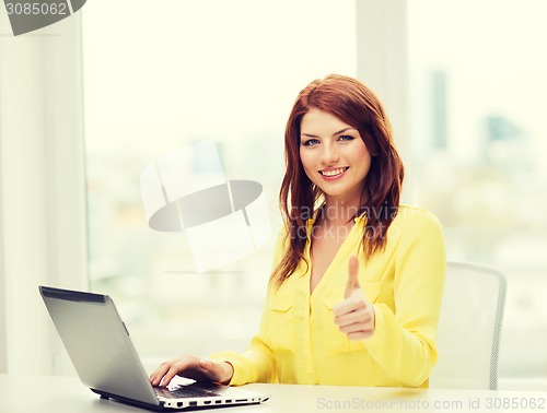 Image of smiling student with laptop computer at school