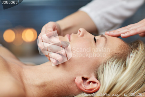 Image of close up of woman having face massage in spa