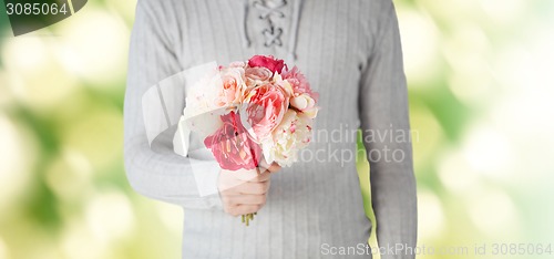 Image of close up of man holding flowers