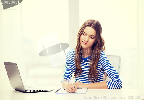 Image of teenage girl laptop computer and notebook