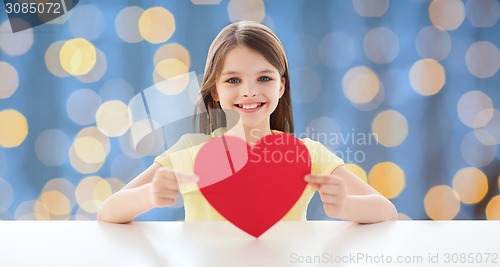 Image of smiling little girl with red heart