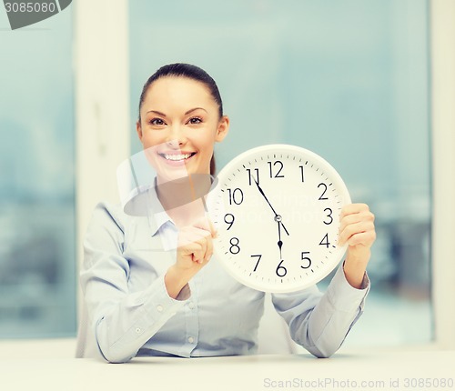 Image of attractive businesswoman with white clock