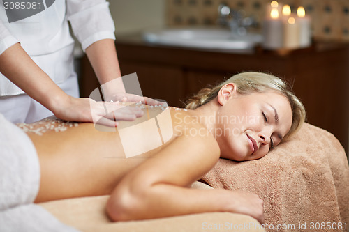 Image of close up of woman lying and having massage in spa