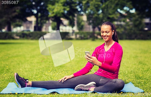 Image of smiling african american woman with smartphone