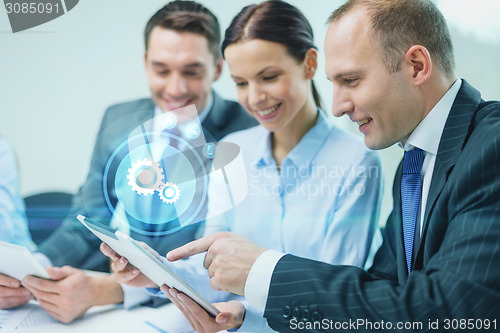 Image of business team with tablet pc having discussion