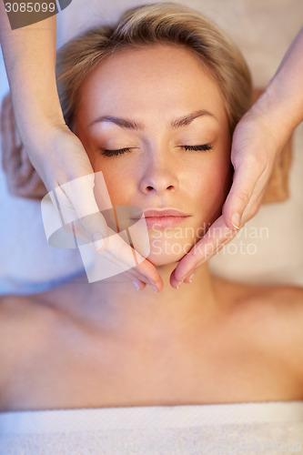 Image of close up of woman having face massage in spa