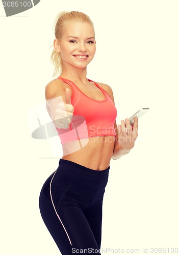 Image of smiling sporty woman with smartphone